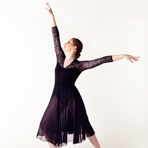 Dancer Amelia in a dance pose, arm outstretched above.