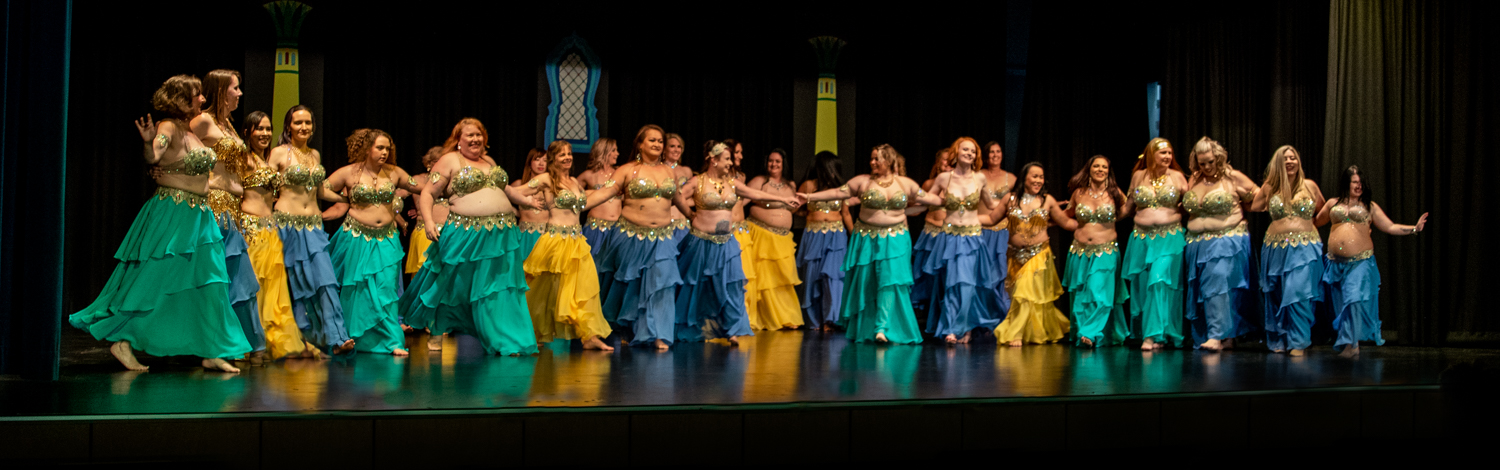 Bellydancers line up onstage in clsoing bars of 30 dancers for 30 years performance